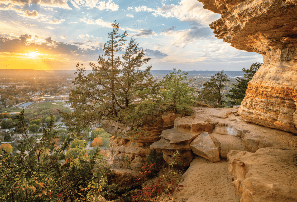 outdoors photo capturing the sunset, foliage and limestone rocks
