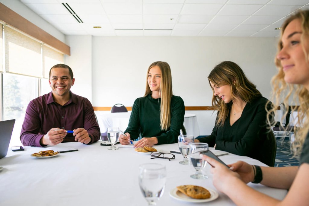 people sitting at a table smiling