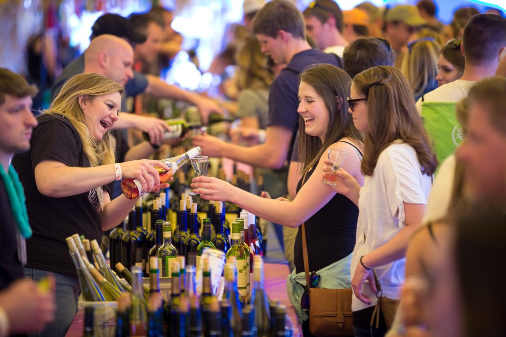 rows of bartenders pouring drinks for festival goers