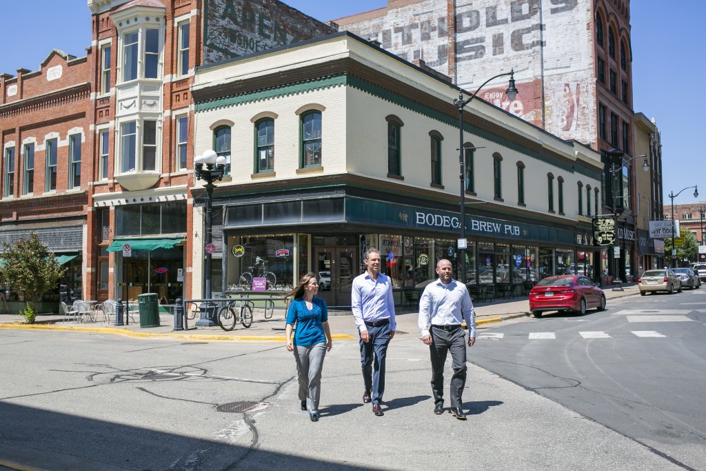 three people walking on the street