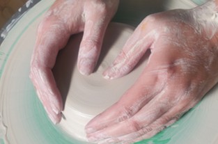 hands doing pottery