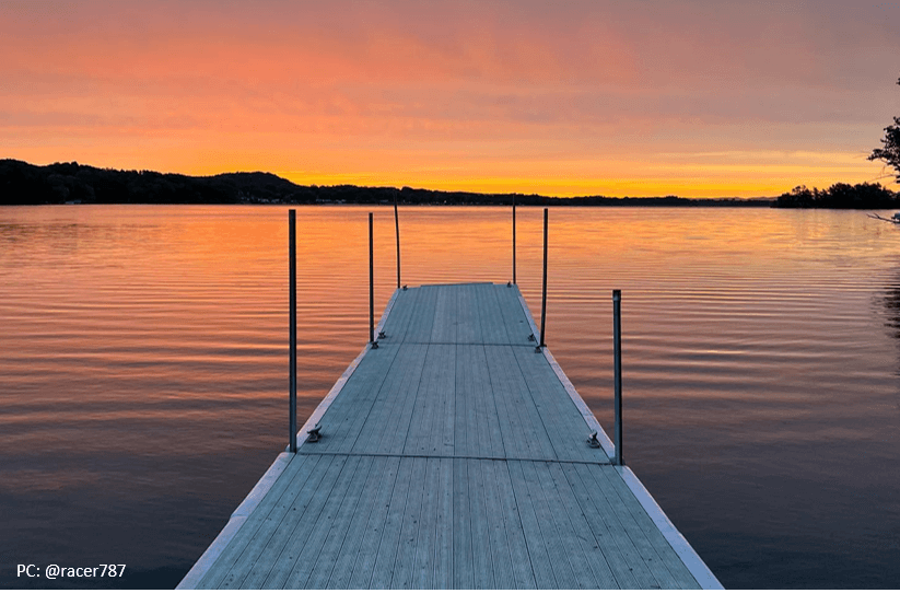 sunset at lake neshonoc in west salem with a view of a dock and open water