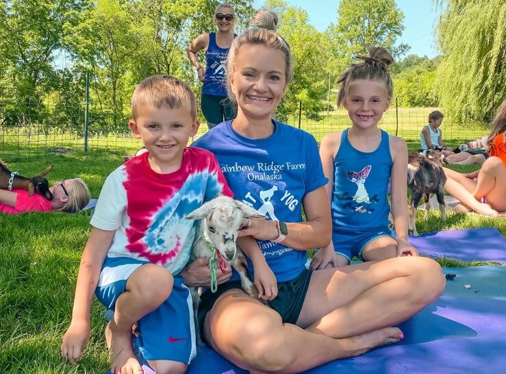 mother with kids and a goat at goat yoga at rainbow ridge