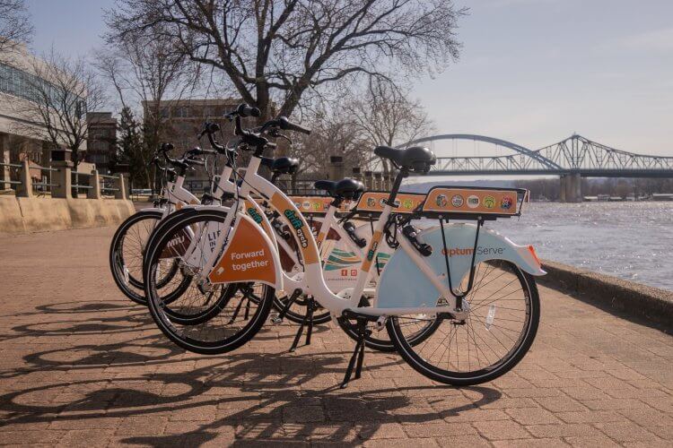 Drift cycle bikes lined up in front of the Mississippi River