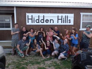 Hidden Hills building with kids pointing to the sign in the front