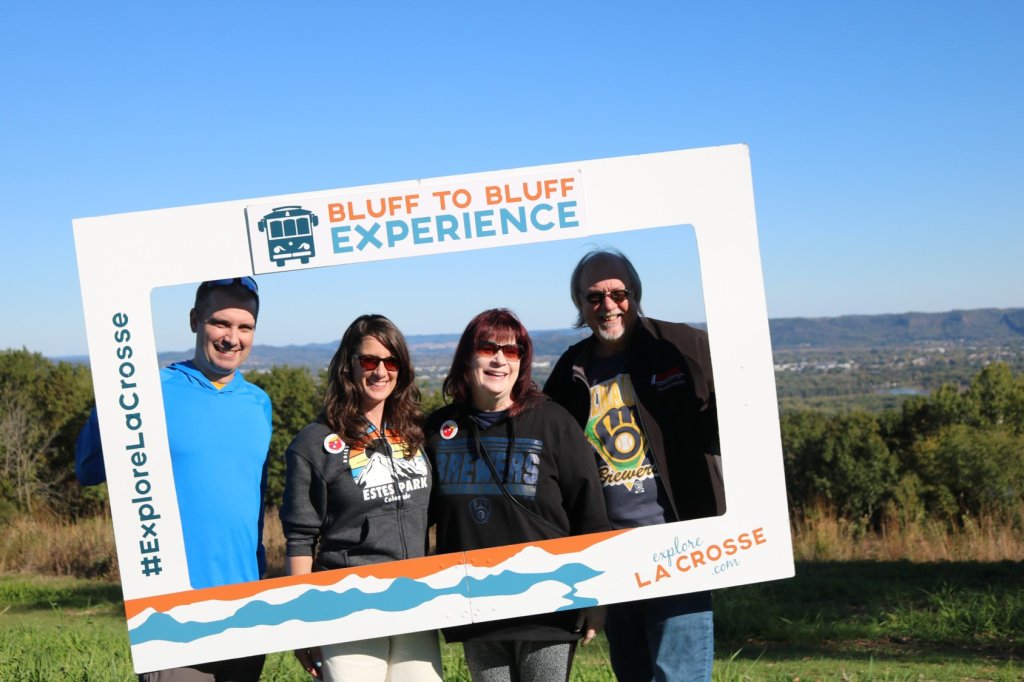 People smiling in a frame for the Bluff to Bluff Trolley Tour Experience at Apple Blossom Scenic Overlook