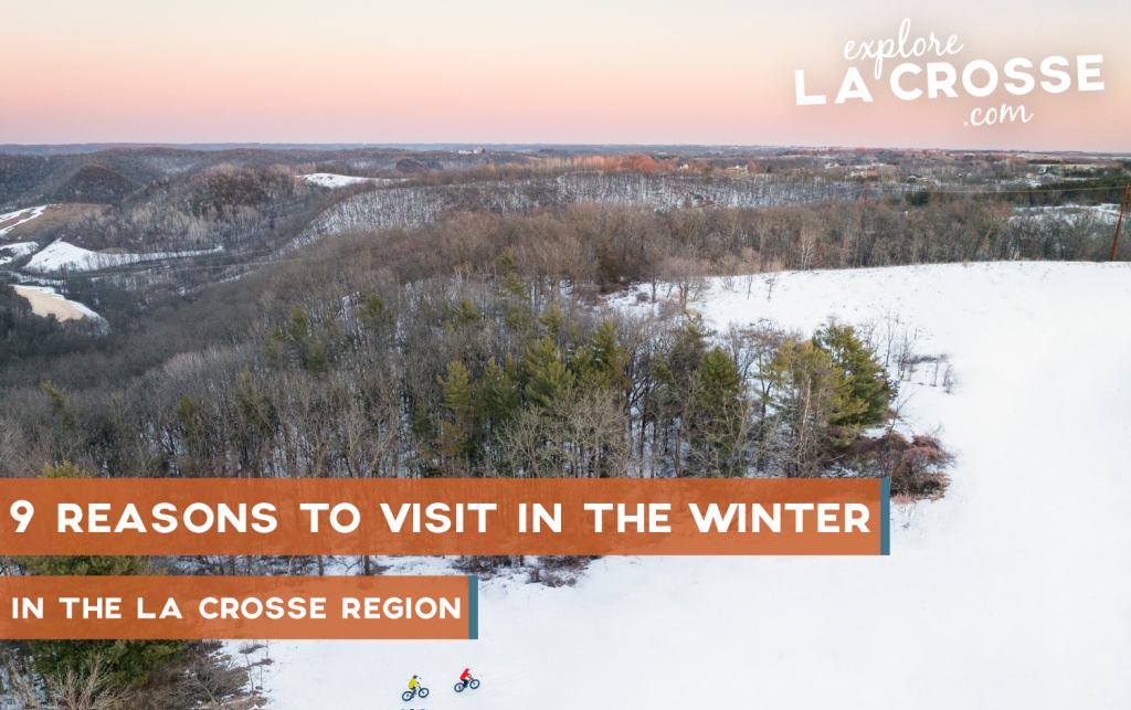 Nine reasons to visit the La Crosse Region in the winter with two people biking over the snow covered bluffs