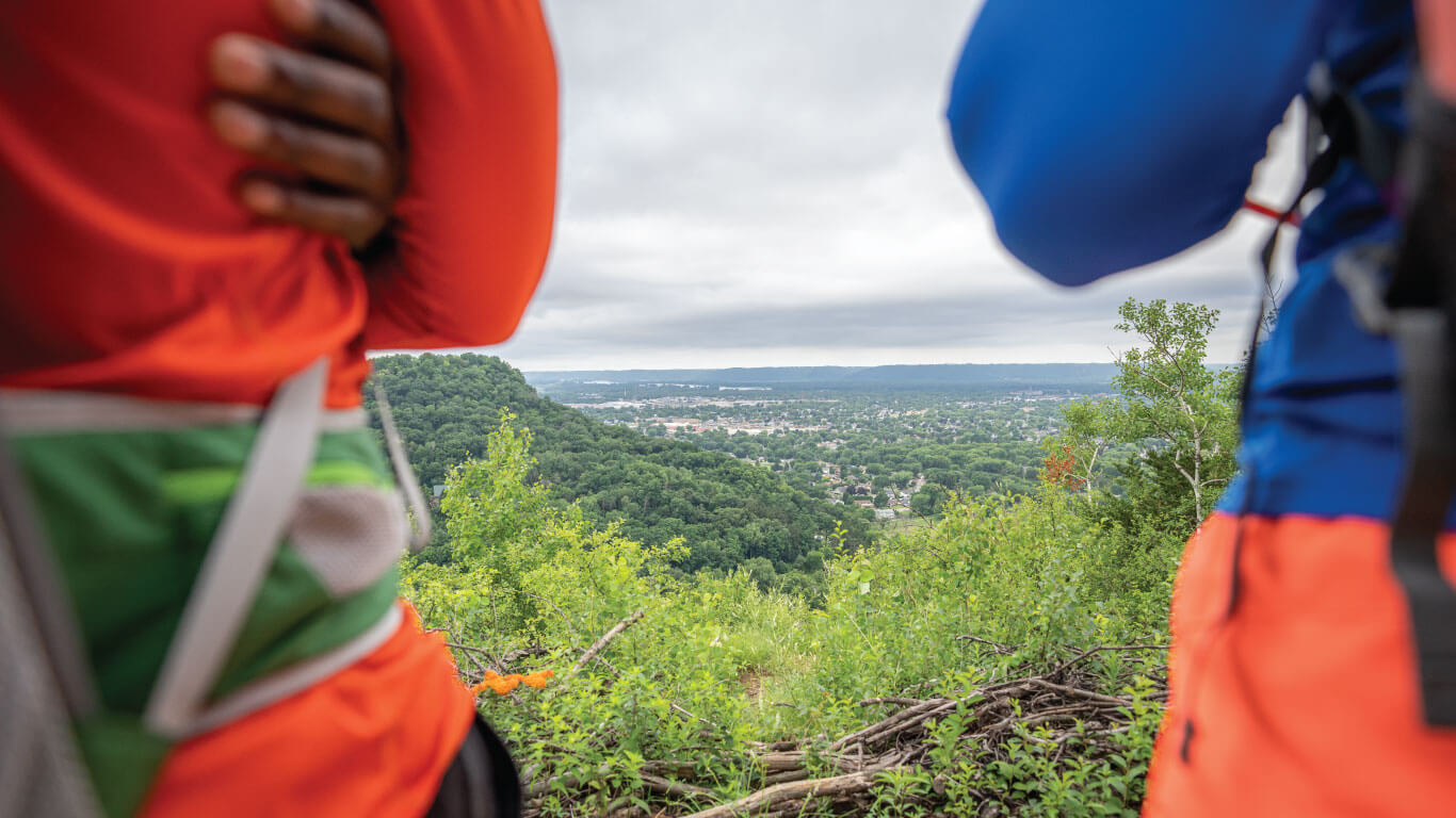 Member Directory 2 two people with arms crossed framing a shot of an overlook of the la crosse region
