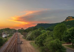 sunset with railroad tracks and Granddad Bluff