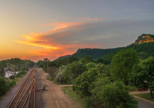 sunset with railroad tracks and Granddad Bluff