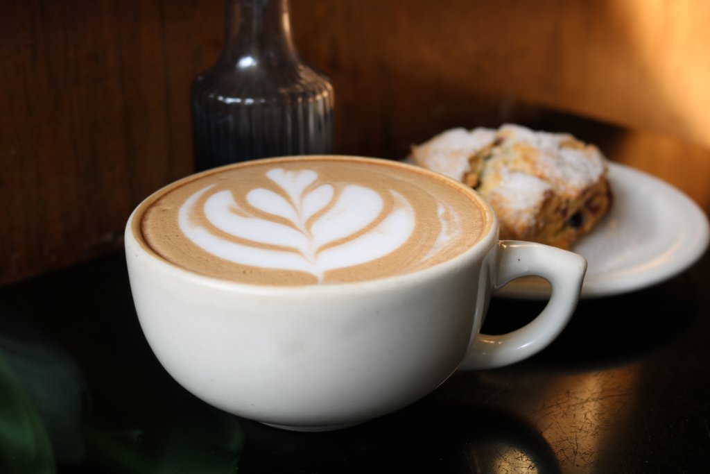 Sunrise to Sunset: Full Day Itinerary 5 a cup of coffee with a leaf design on the foam