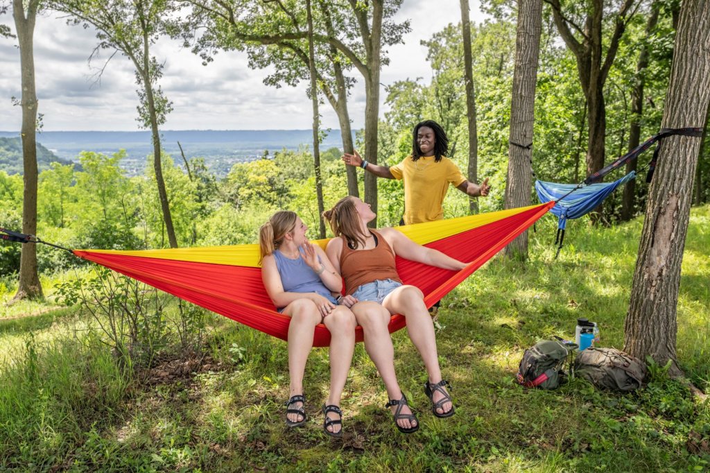 a group of people sitting in a hammock