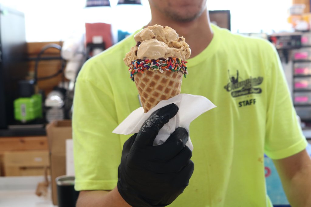 Man giving an ice cream cone from Champions Riverside Resort