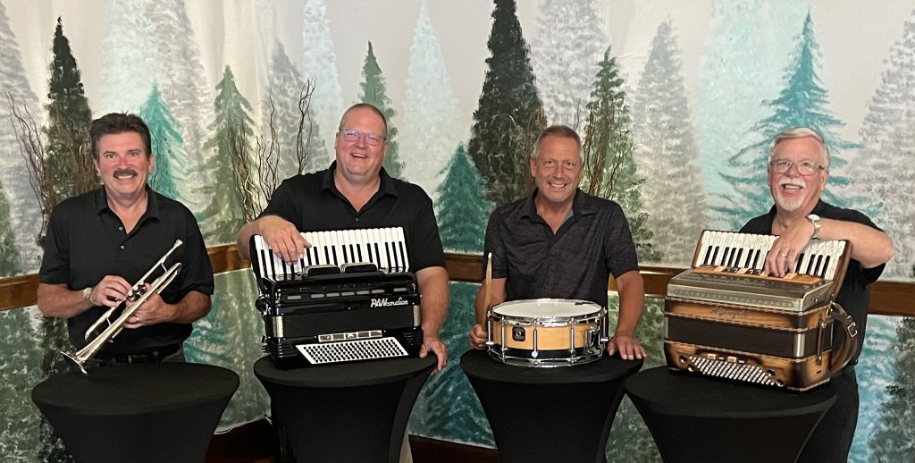 four men standing next to each other with musical instruments