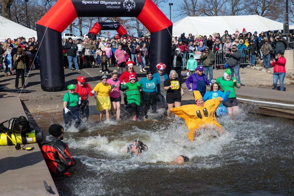 a group of people in clothing in a pool of water