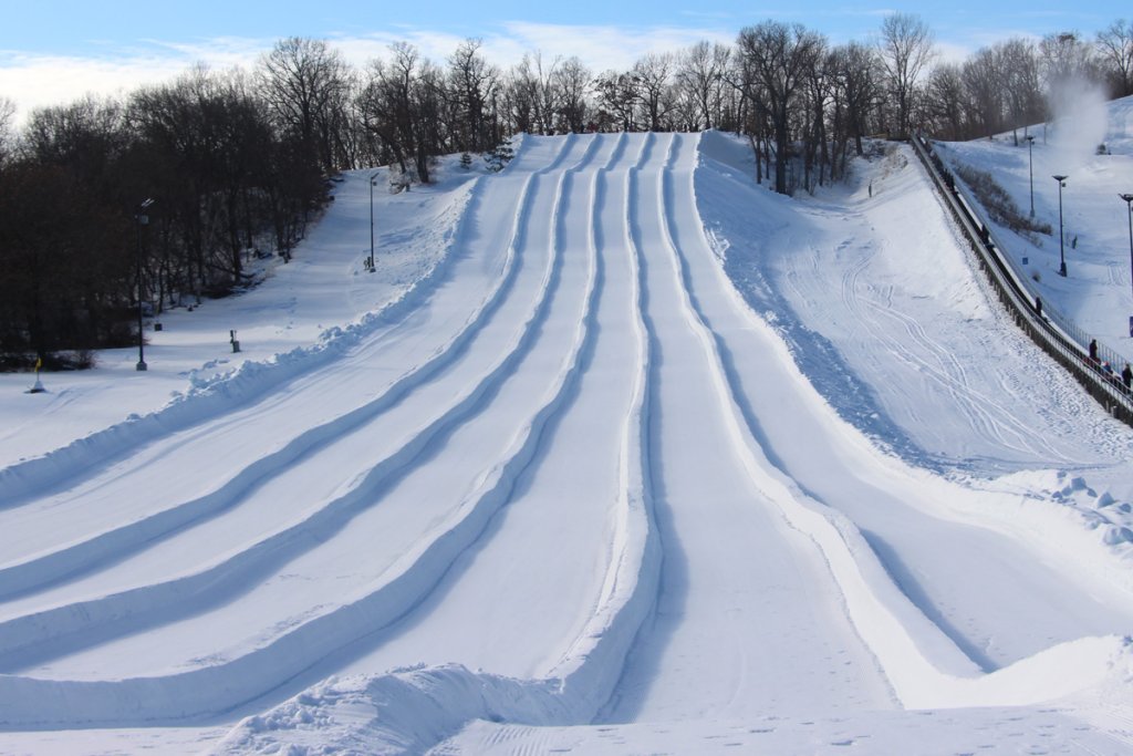 a snow covered hill with ski tracks