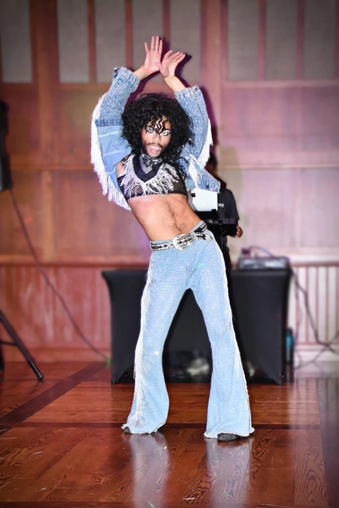 a drag performer in jeans