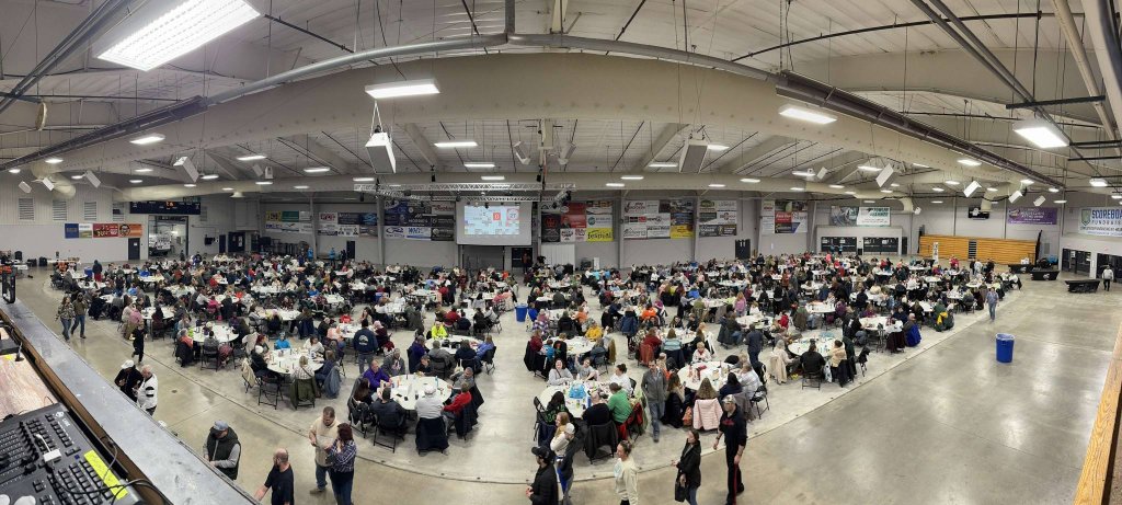 a large room full of people sitting at tables