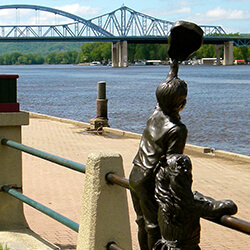a statue of two children on a railing