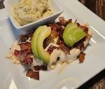 a plate of food with a side of mashed potatoes