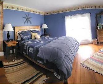 a bedroom with a bed and a lamp