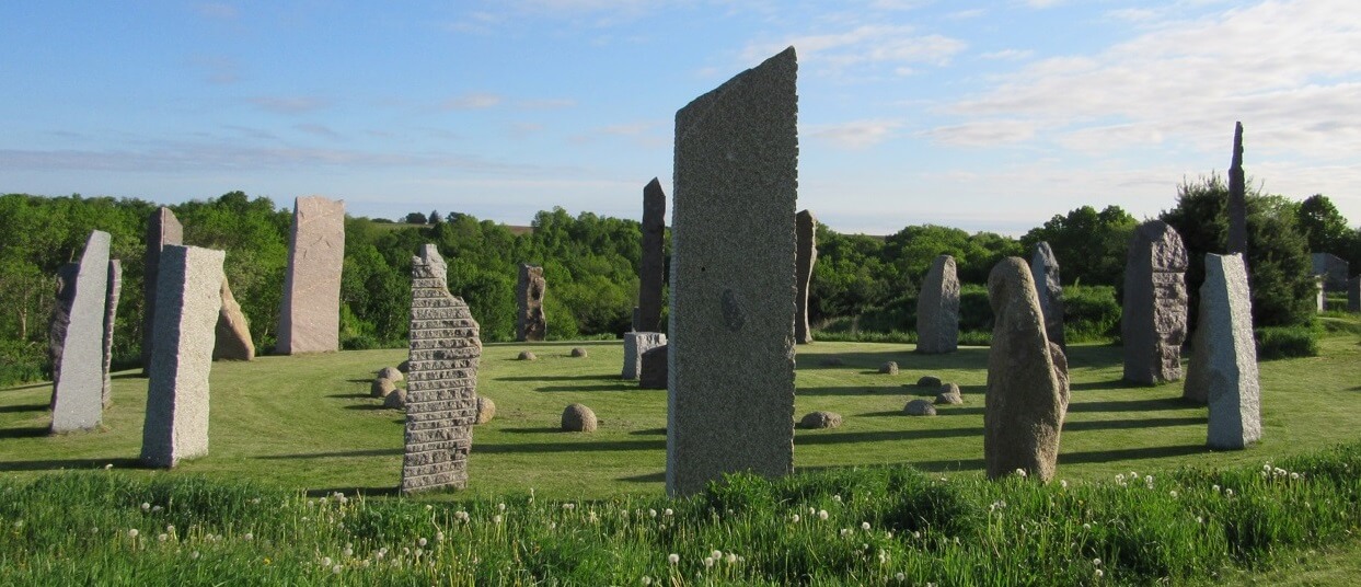 a group of stone pillars in a field