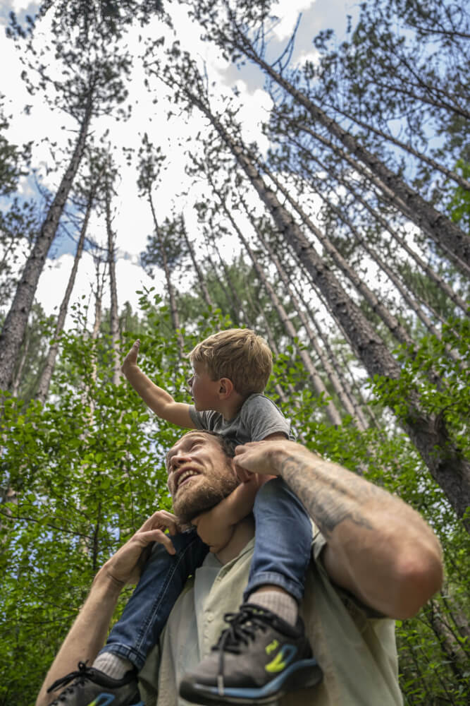 a man carrying a child on his shoulders