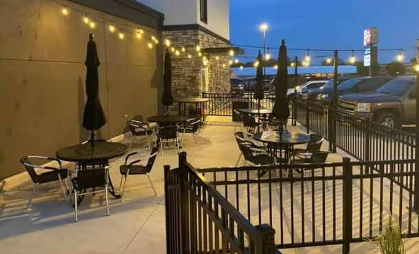 a patio with tables and chairs