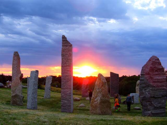 a group of people standing in a field of rocks