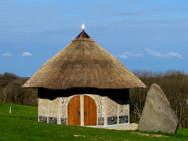 a small building with a thatched roof
