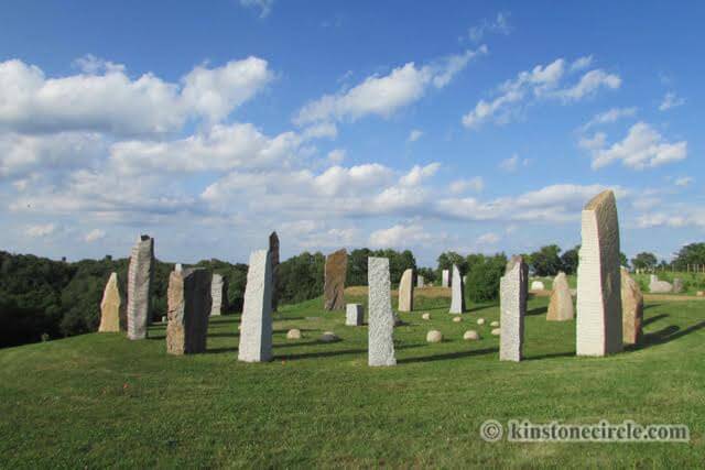 a group of stone pillars in a field