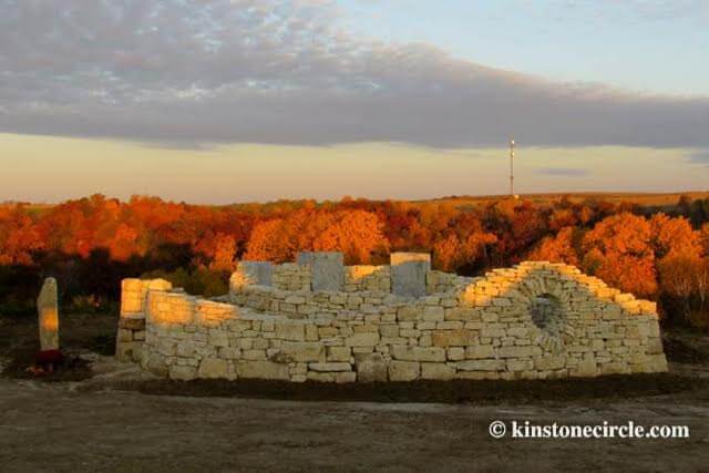 a stone structure with trees in the background