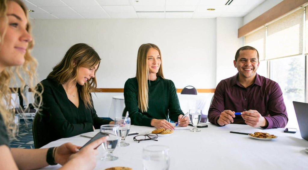 Planning Services 7 people sitting at a table smiling
