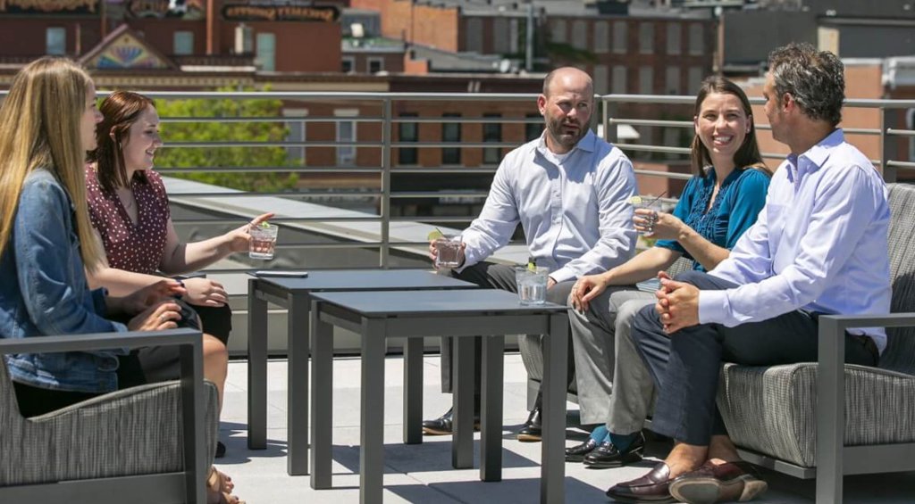 Reasons to Meet 6 a group of people sitting on a patio