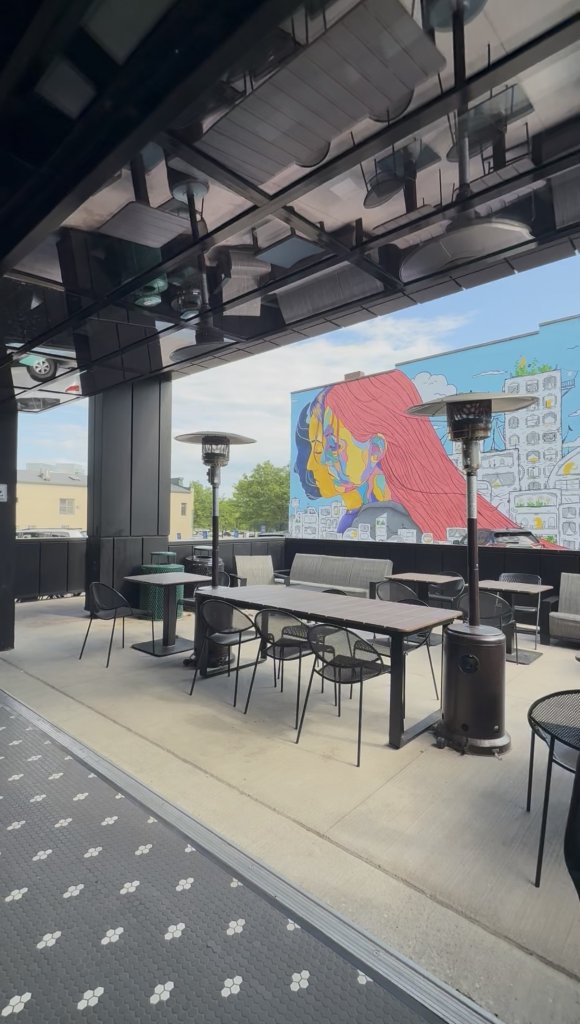 Free Range Exchange's outdoor patio area with a view of the mural