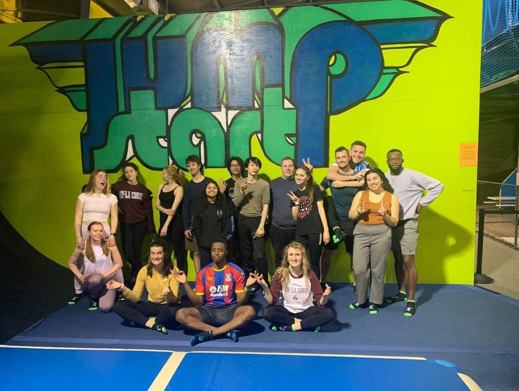 image-group-of-people-in-front-of-sign