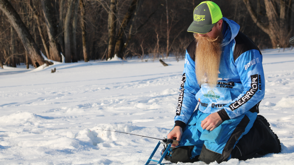 Man ice fishing on the back pools of the Mississippi River in winter