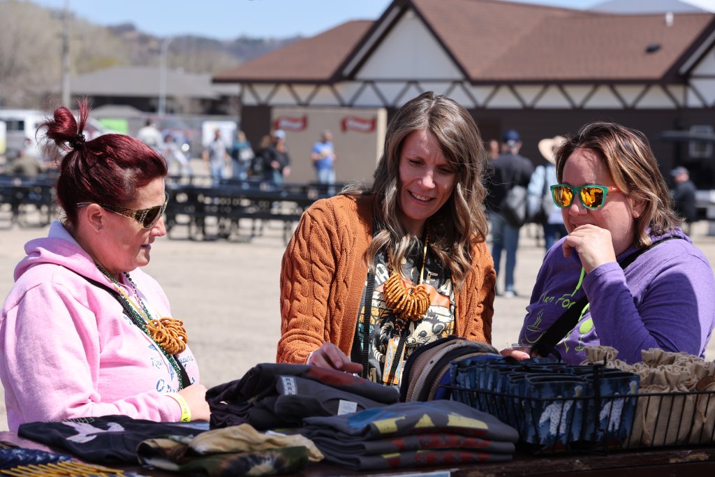 3 Women looking at Apparel at Beer, Wine and Cheese Festival