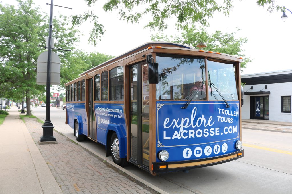 Blue Explore La Crosse Trolley parked on a side of street
