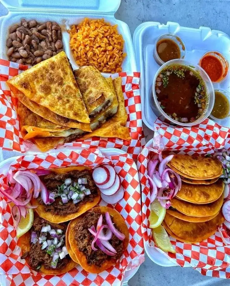 a table full of mexican food, tacos,and more