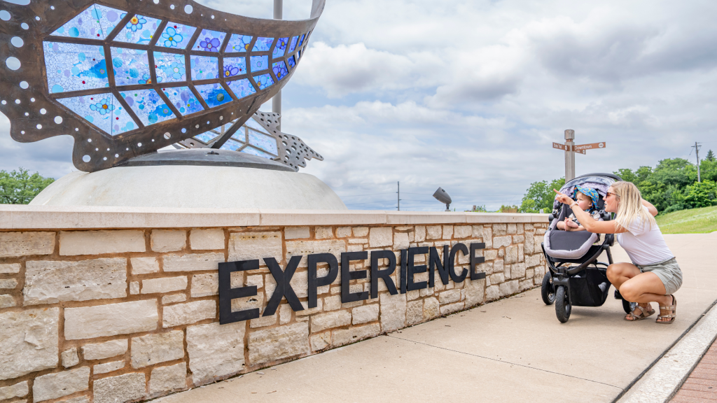 Mother and son looking at an art piece outside