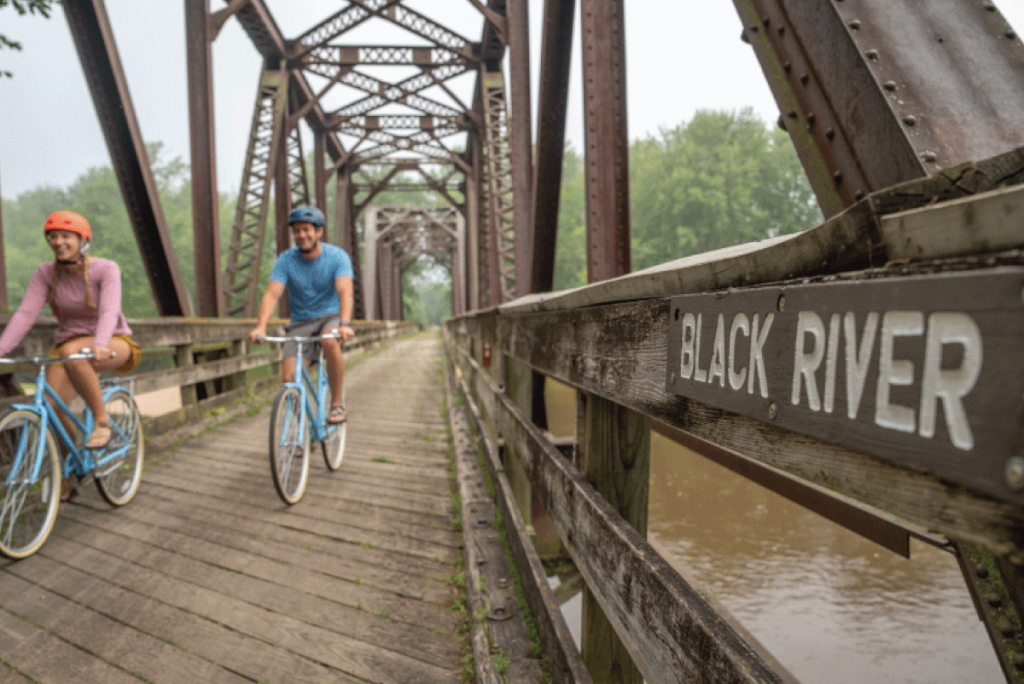 Cyclists on a bridge over the Black River in La Crosse Wisconsin during the summer months.