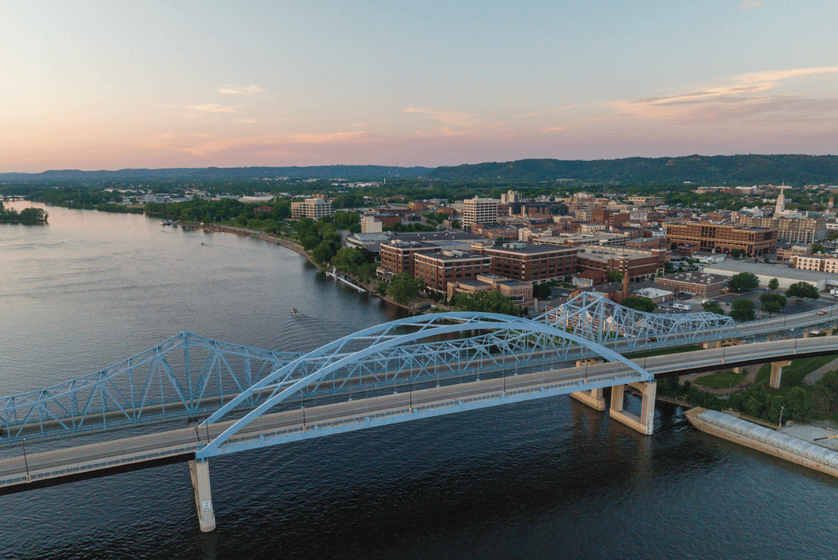 Aerial view of the Cass Street Big Blue Bridge and historic downtown La Crosse of Wisconsin next to the Mississippi River at sunrise.