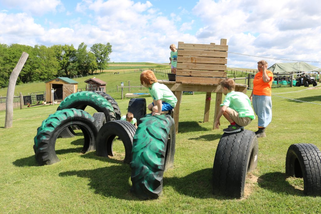 children playing on giant tire playset