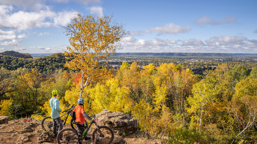 two person biking at an overlook during peak fall foliage