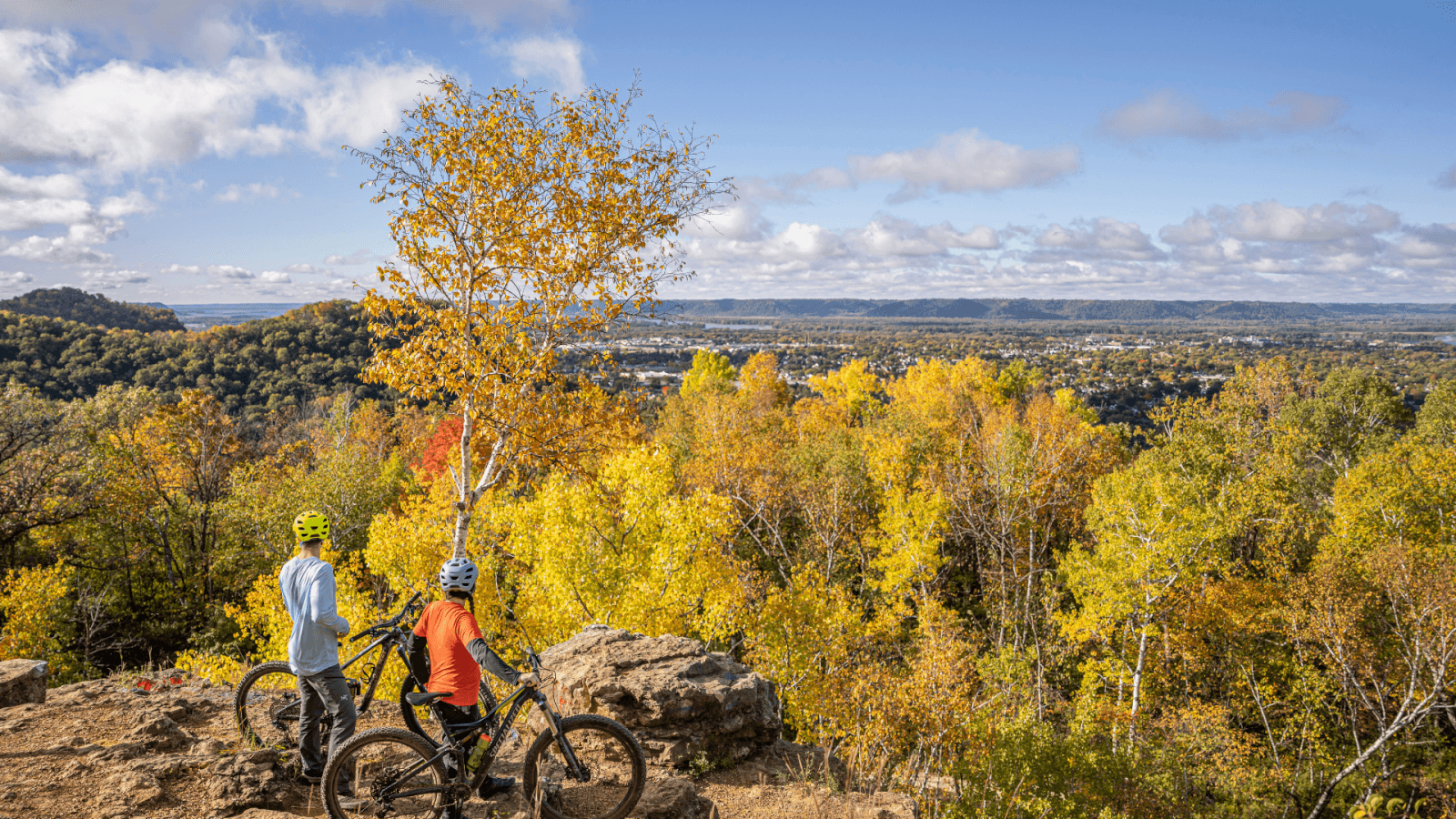Biking in the La Crosse Region two person biking at an overlook during peak fall foliage