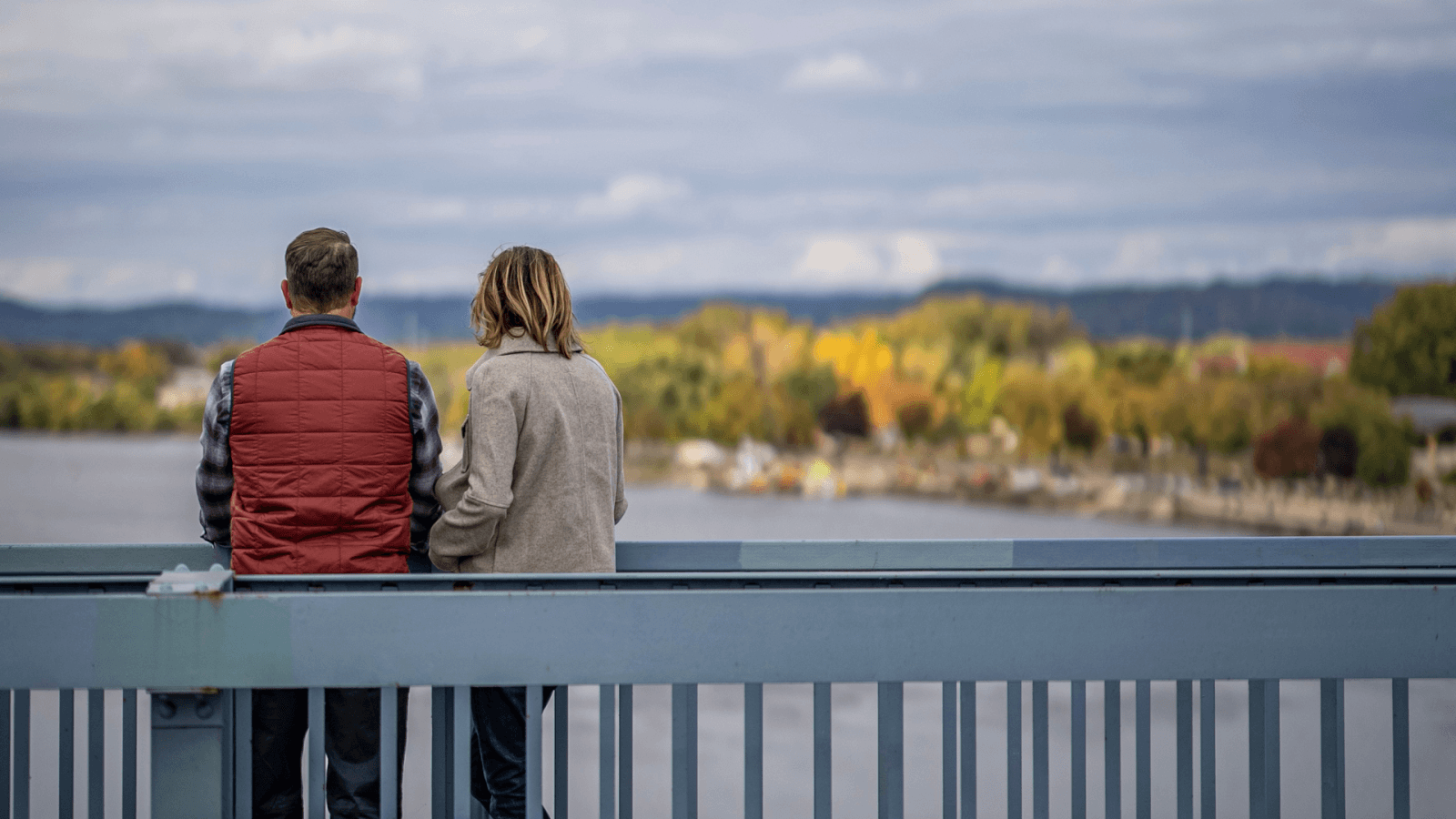 Win with Explore La Crosse couple overlooking the mississippi river on the big blue bridge